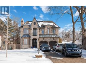 A large house with a carport and a car in front.