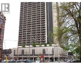 A tall building with many windows is in the background.