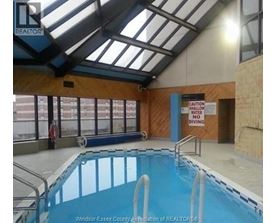 A pool with a sign that says "Caution Water Shallow No Diving".