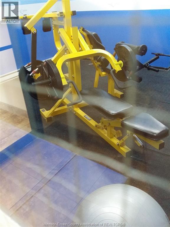 A yellow gym machine is in the foreground of the image.
