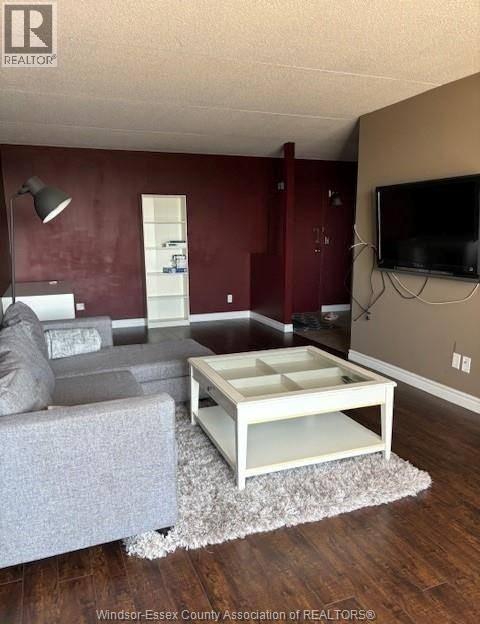 A living room with a grey couch and a white coffee table.