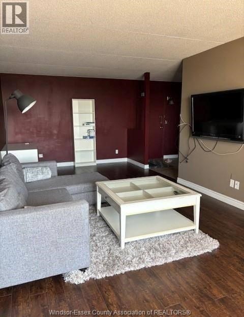 A living room with a grey couch and a white coffee table.