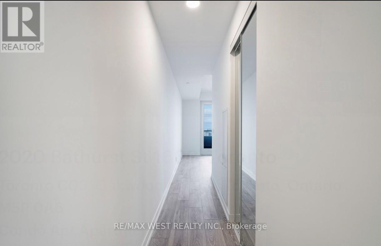 A long, narrow hallway with a door at the end.