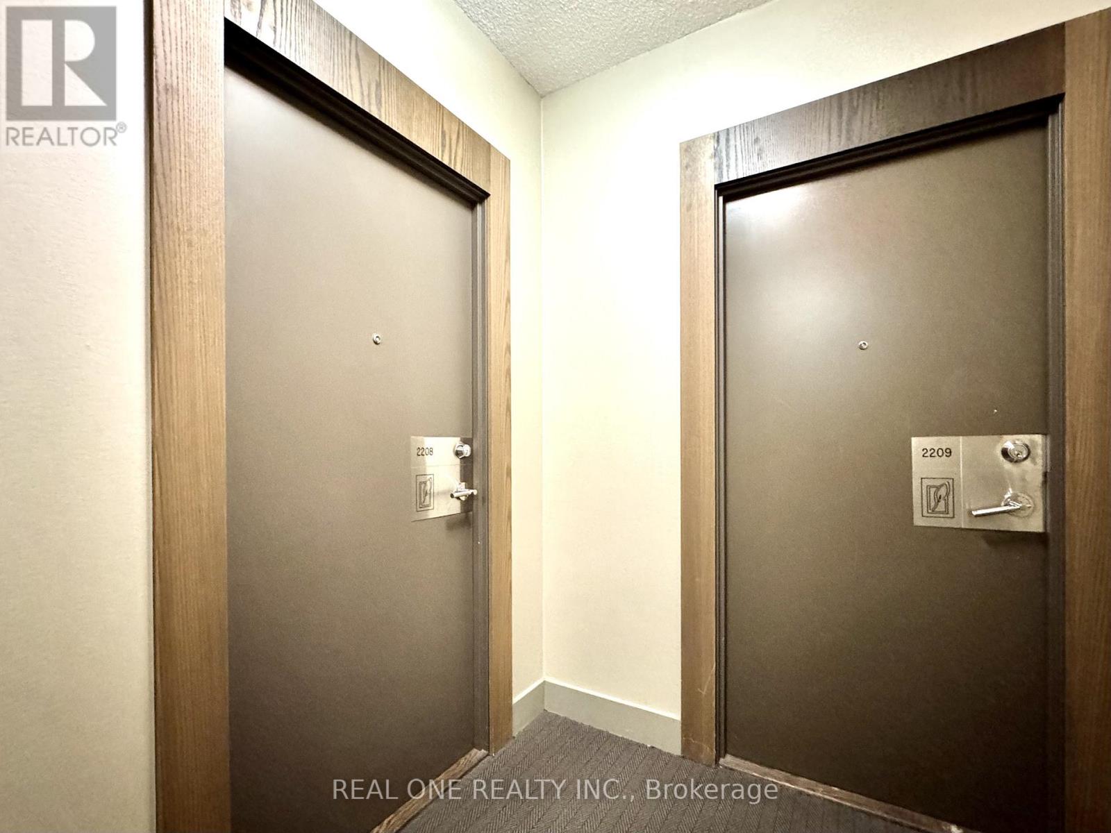 Two doors with Real One Realty Inc. logo on them.