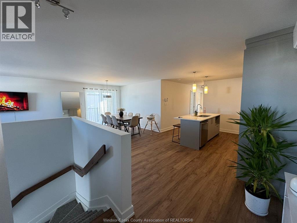 A living room with a television and a dining table.