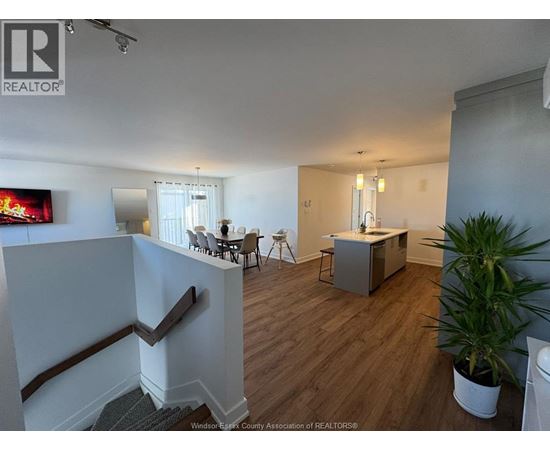 A living room with a television and a dining table.