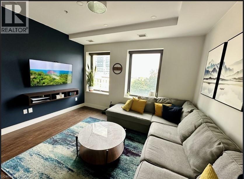 A living room with a grey couch and a round coffee table.