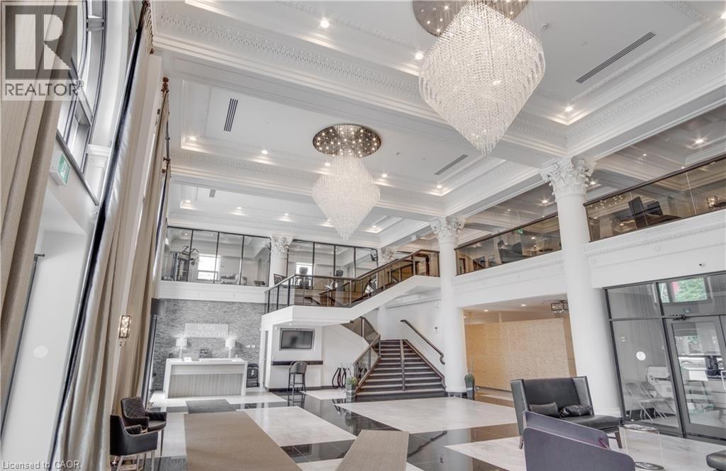 A spacious lobby with a staircase and a chandelier.