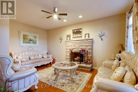 A living room with a fireplace and a painting on the wall.
