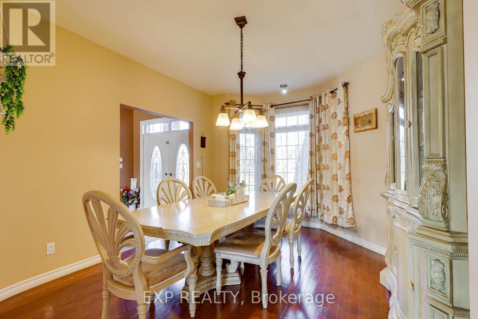 A dining room with a table set for four.