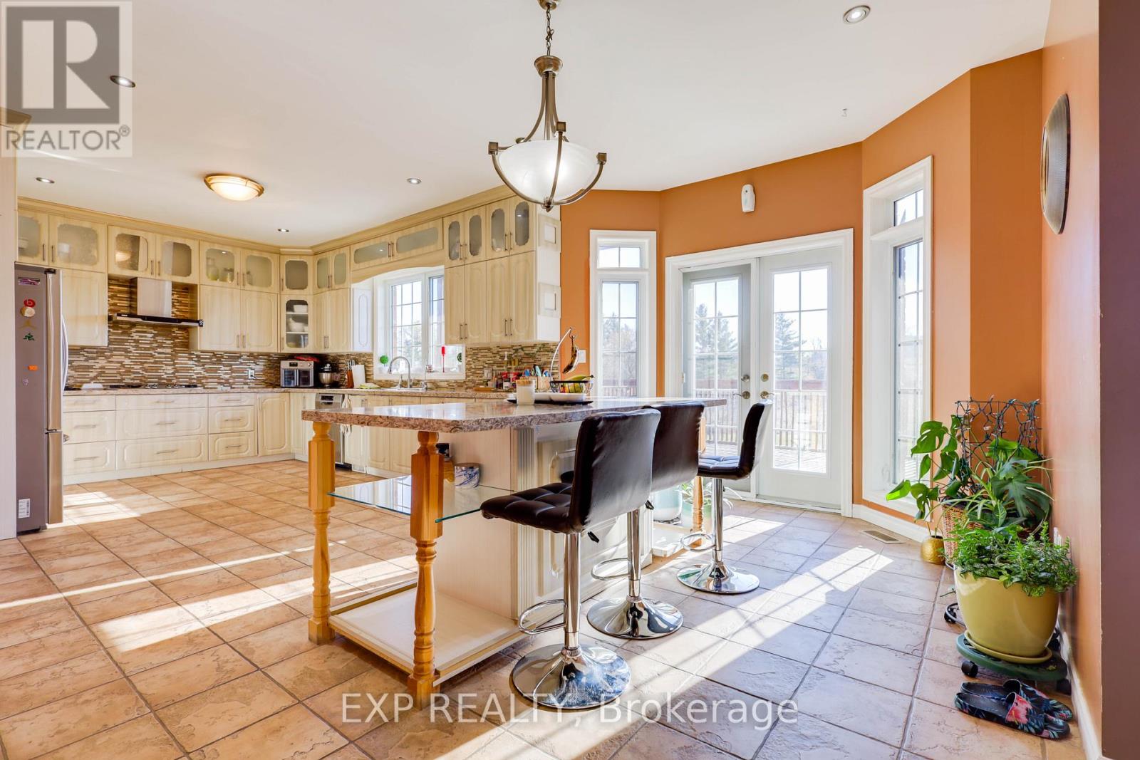 A kitchen with a table and chairs in the middle of the room.
