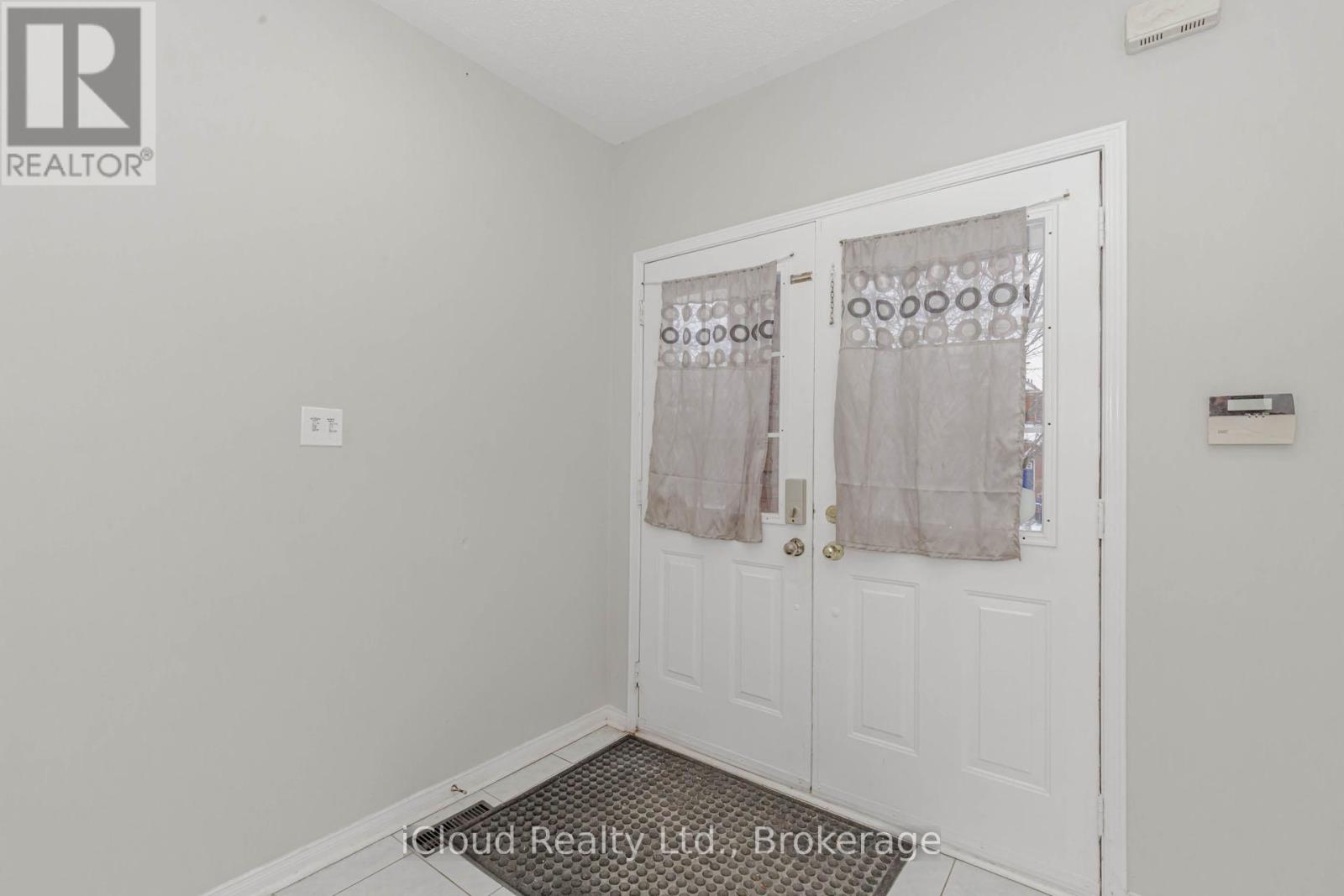 A white door with a glass window and curtains.