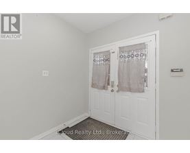 A white door with a glass window and curtains.