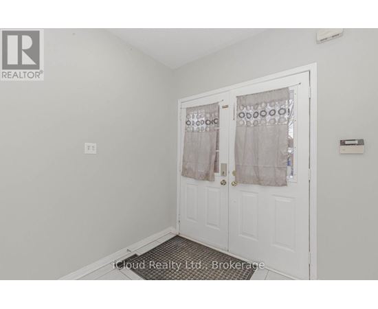 A white door with a glass window and curtains.