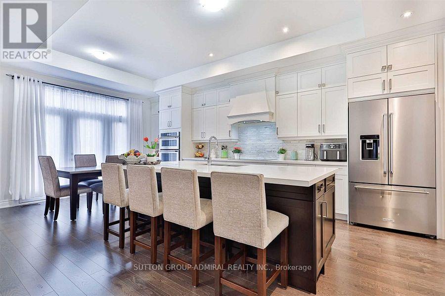 A modern kitchen with a dining table and chairs.