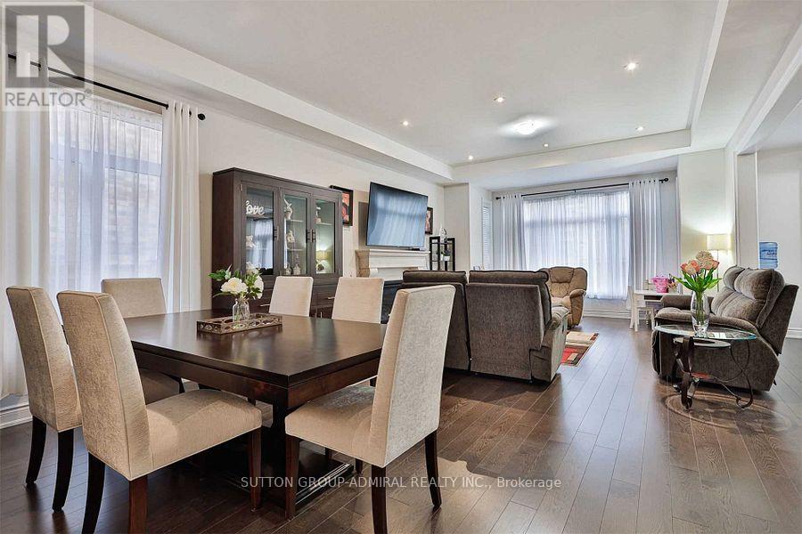 A dining room with a dark wood table and chairs.