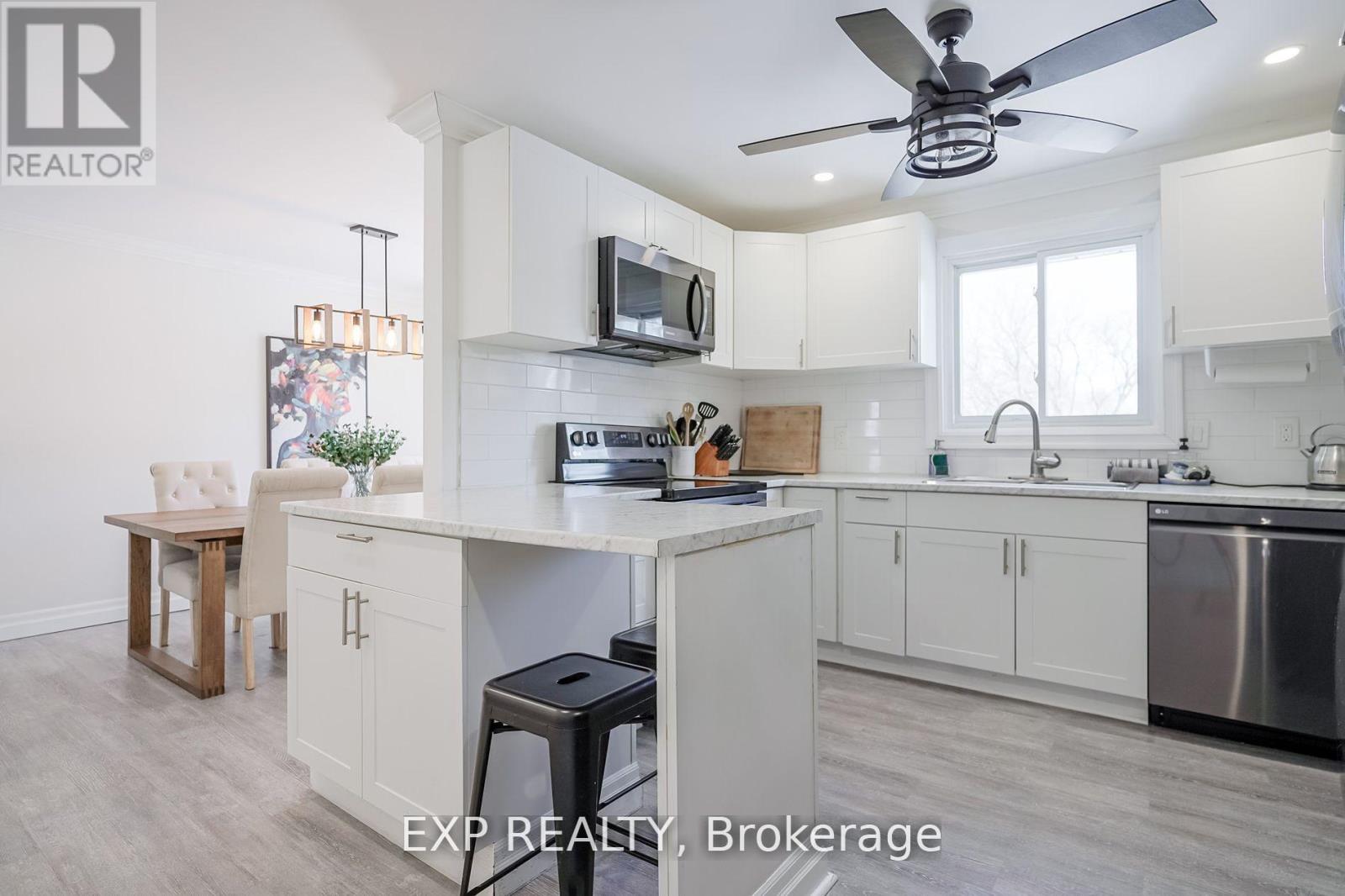 A kitchen with white cabinets and a wooden table.