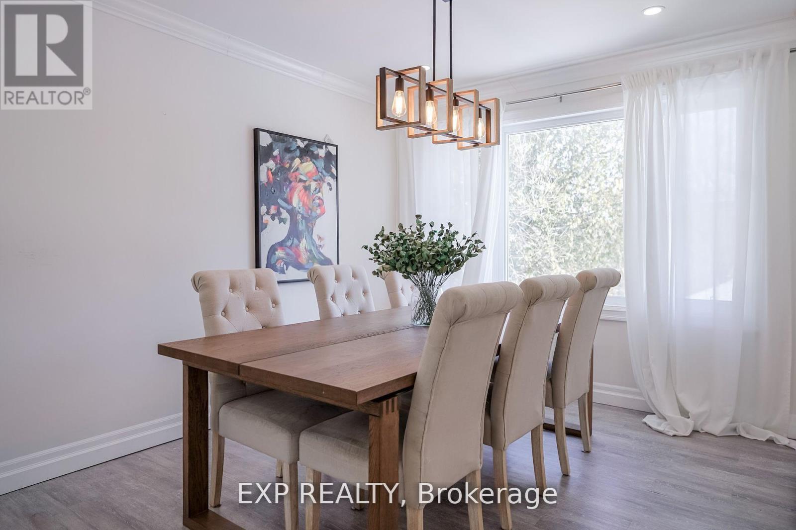 A dining room with a wooden table and chairs.