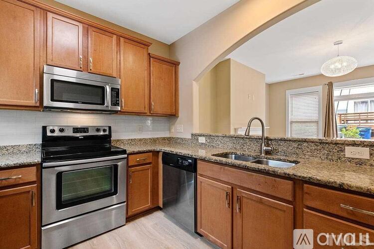 A kitchen with wooden cabinets and stainless steel appliances.