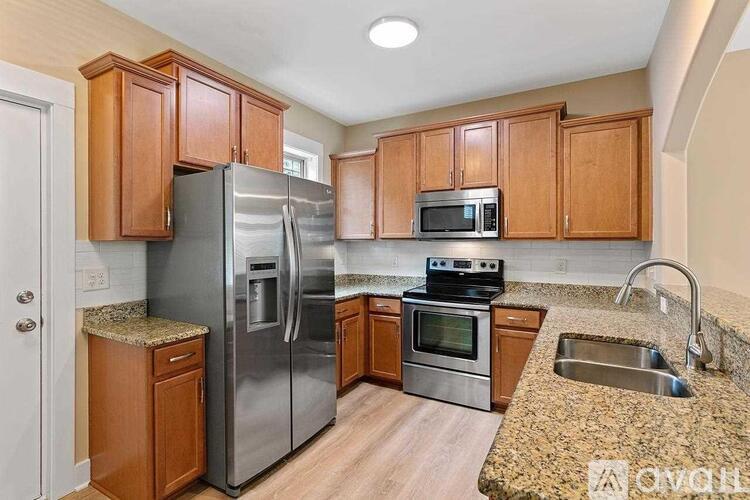 A kitchen with granite countertops and stainless steel appliances.
