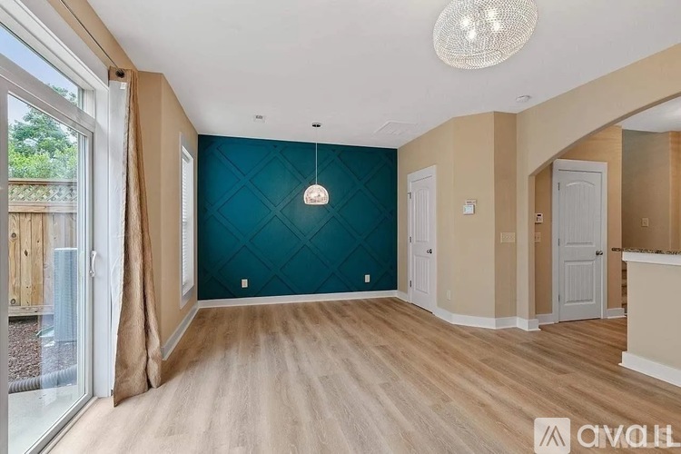 A room with a wooden floor and a ceiling light.