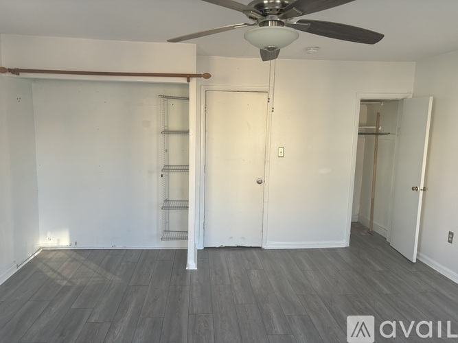 A room with a ceiling fan and a sliding door.