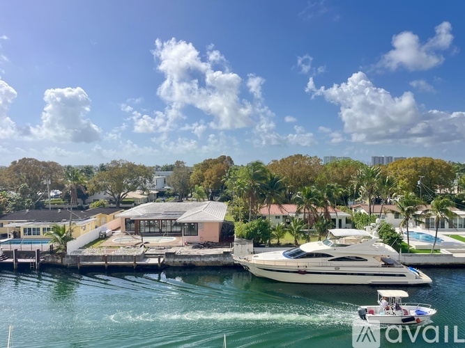A boat is sailing in the water near a dock.