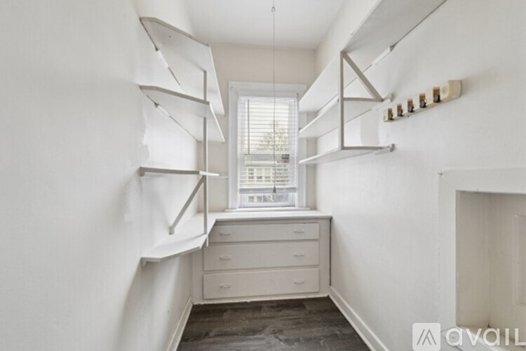 A bathroom with a white sink and a bathtub with a glass shower door.