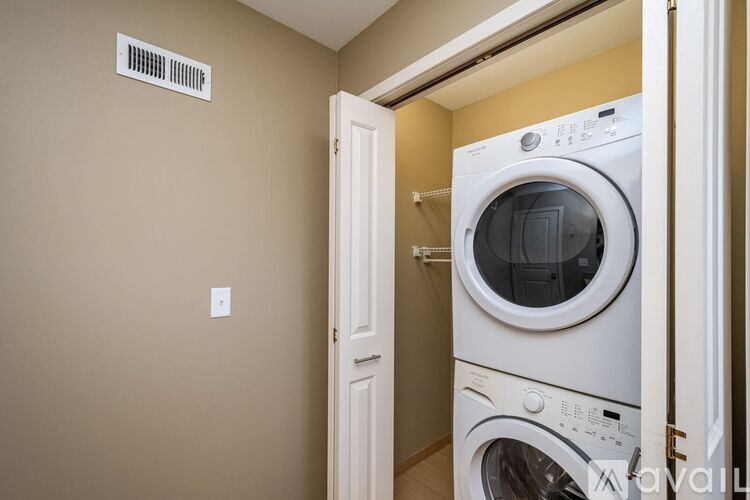 A white washing machine in a laundry room.