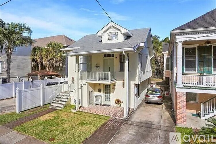 A house with a car parked in front of it.