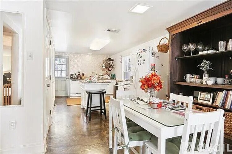 A kitchen with a table and chairs in the middle of the room.