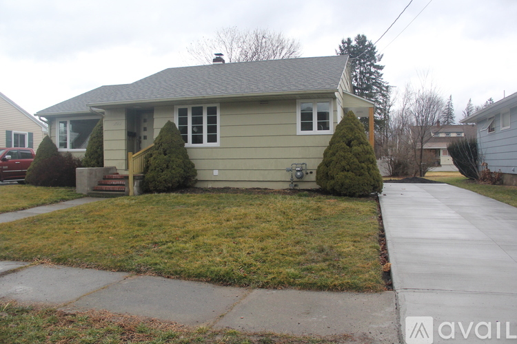 A house with a green lawn and a grey roof.