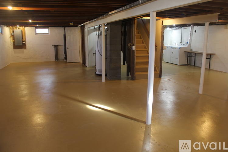 A spacious room with a staircase leading to another level.