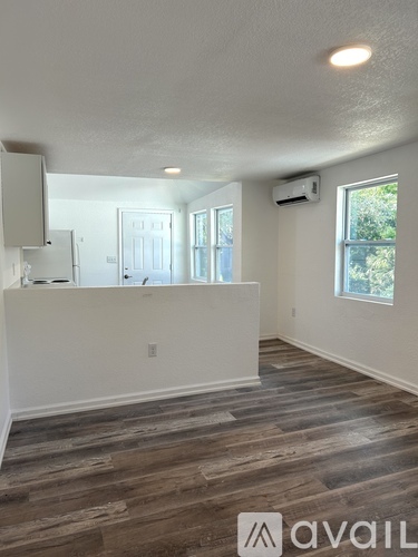 A room with wooden flooring and a window.