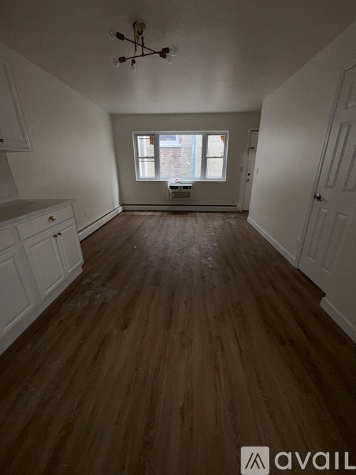 A room with wooden floors and white walls.