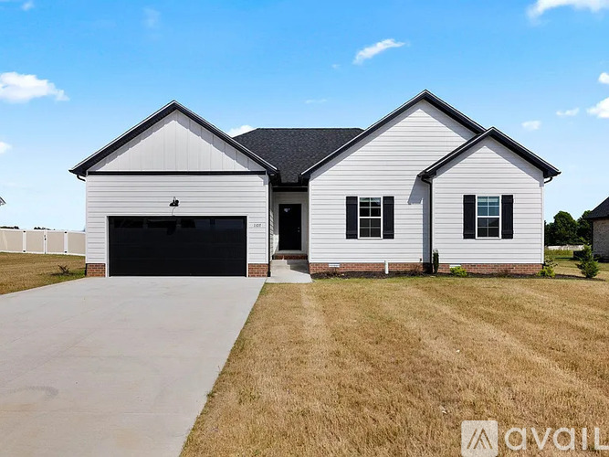A two-story house with a garage is available for sale.