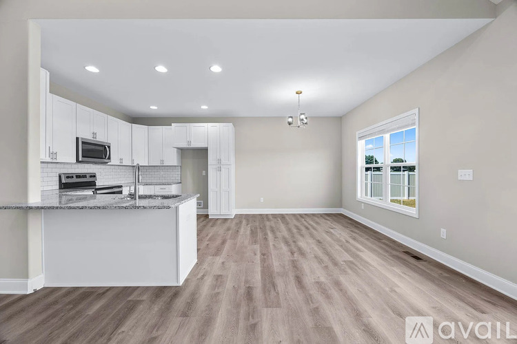 A spacious kitchen with a countertop and a window.