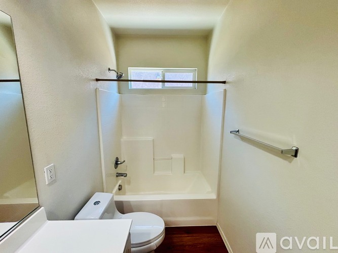 A bathroom with a toilet, sink, and bathtub.