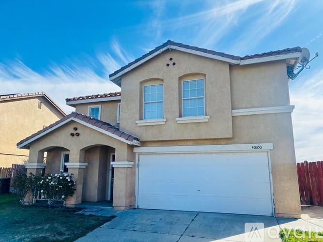 A two-story house with a garage is located in a residential area.