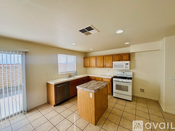 A kitchen with wooden cabinets and a white stove top oven.