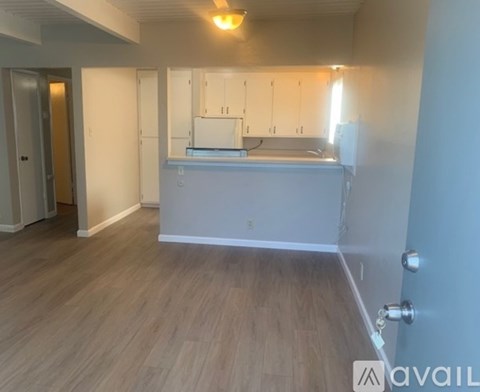 A kitchen area with a counter and cabinets.