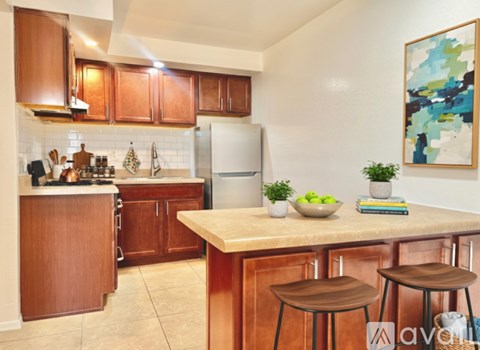 A kitchen with wooden cabinets and a white refrigerator.
