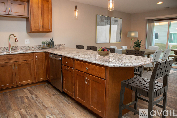 A kitchen with wooden cabinets and a granite countertop.