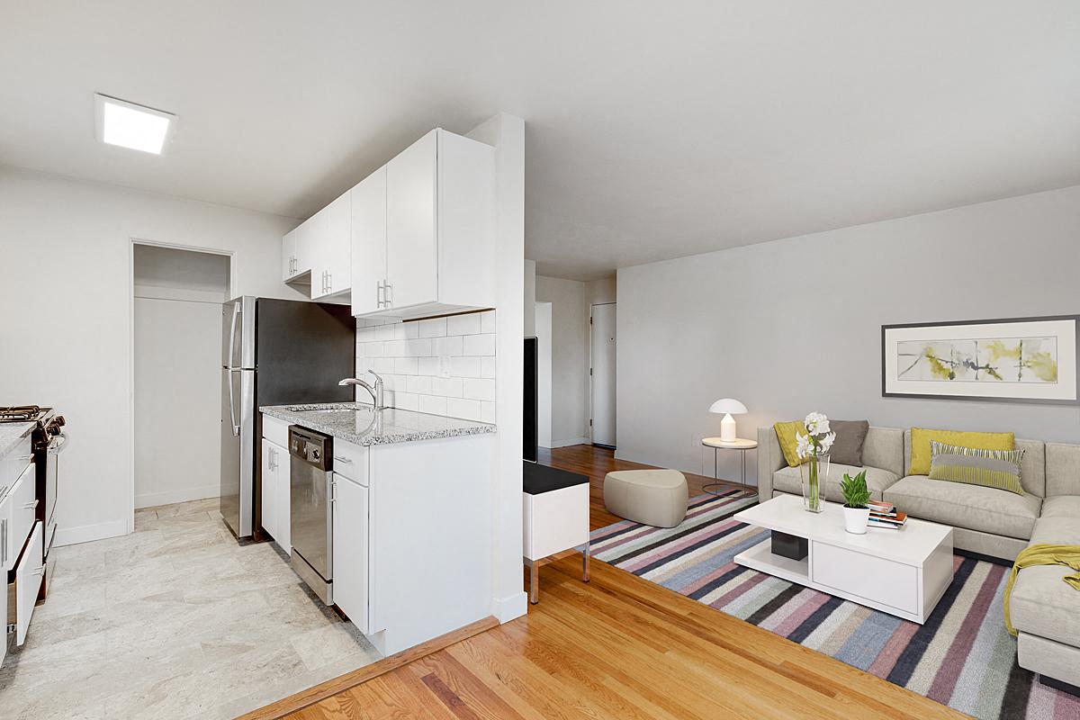 a living room with a kitchen and a couch