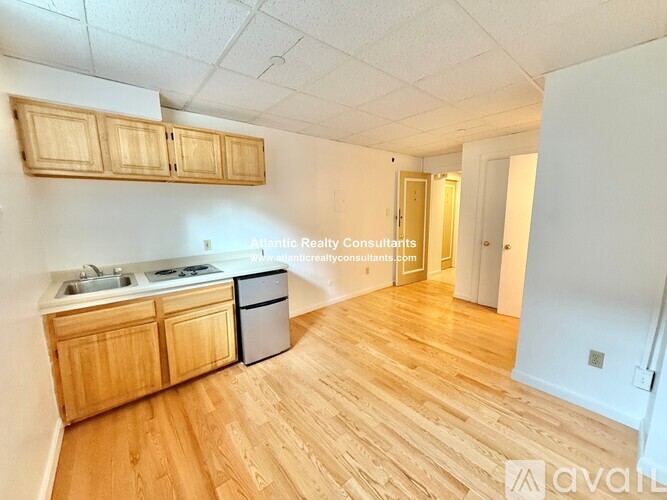 A room with wooden flooring and a window.