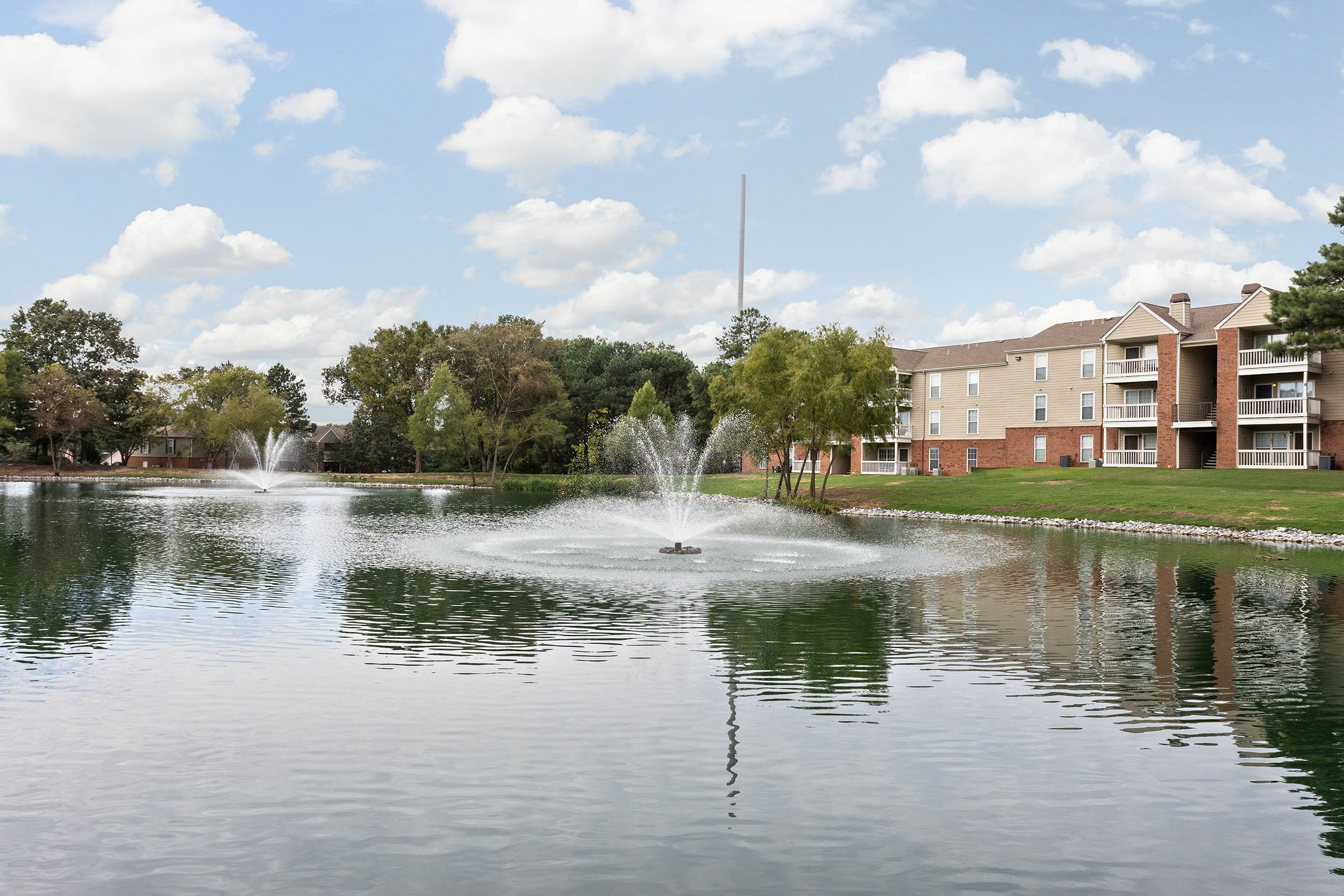 Stunning outdoor view of lake with fountain elements at Cordova apartments for rent