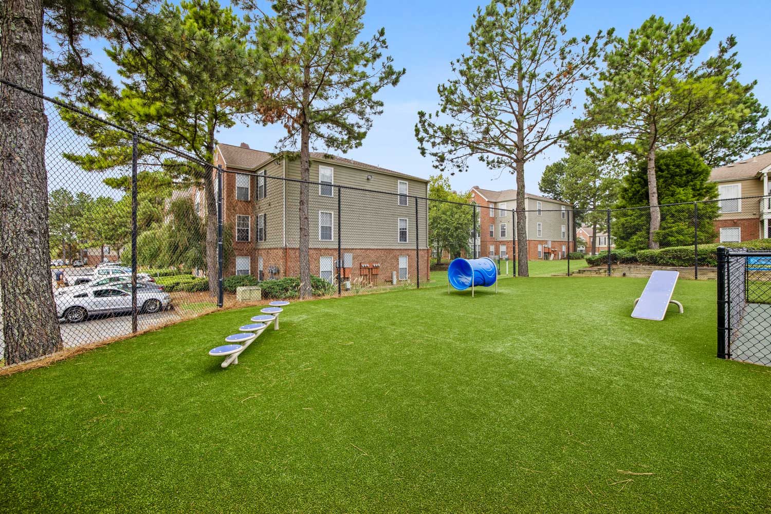 Private, fenced and off-leash dog park with toys and obstacles for residents of pet-friendly apartments near Memphis