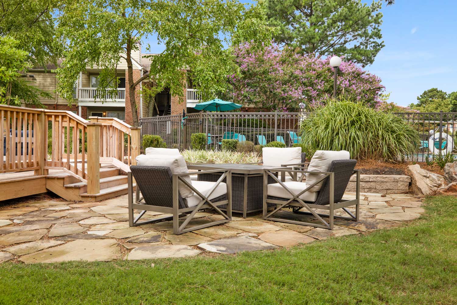 Fireside lounge with lounge chairs surrounded by landscaping