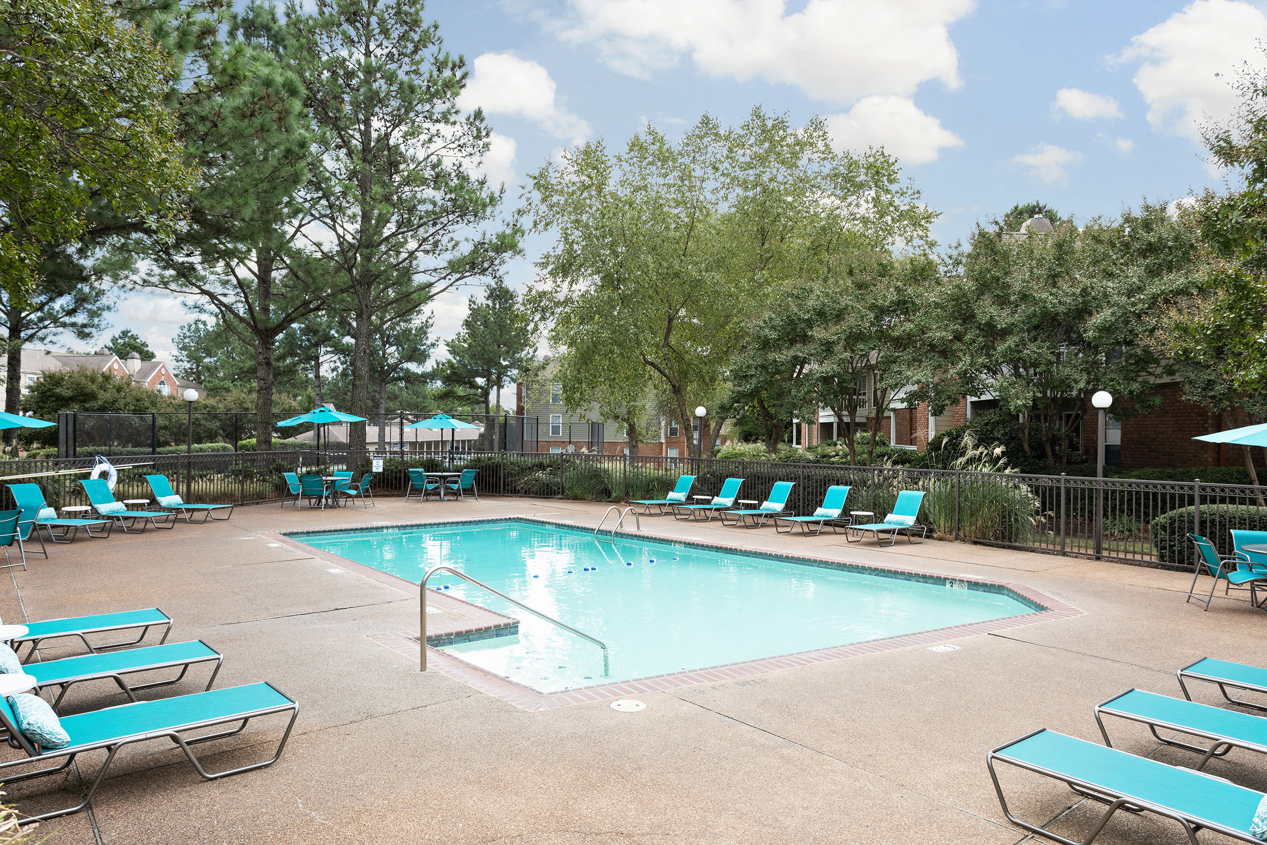 Gorgeous apartment swimming pool with sundeck and numerous lounge chairs