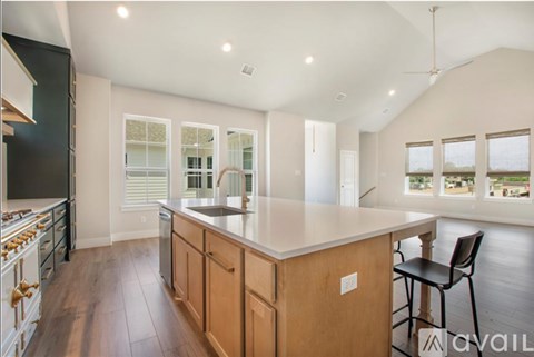 A modern kitchen with wooden cabinets and a large island.